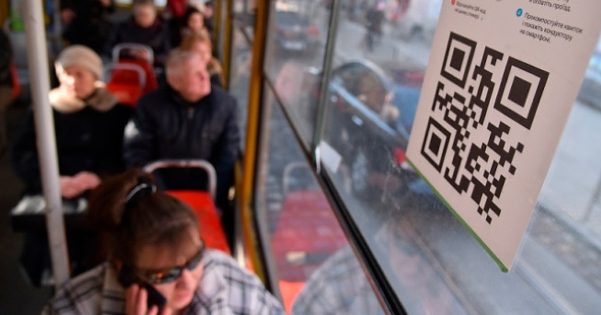 Ақтөбе тұрғыны автобусқа өзінің QR-кодын жабыстырып, жолақысын алып отырған