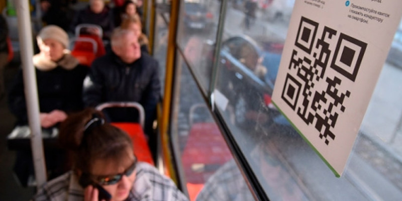 Ақтөбе тұрғыны автобусқа өзінің QR-кодын жабыстырып, жолақысын алып отырған